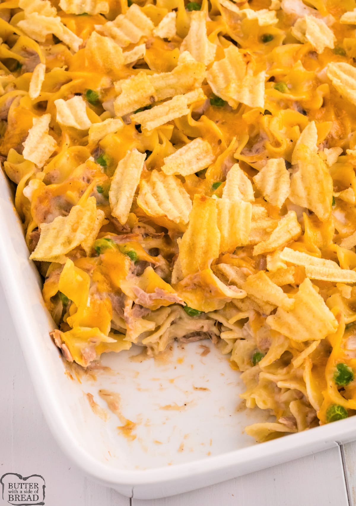 Tuna Noodle Casserole is the perfect comfort food recipe for a weekday dinner. This tuna casserole recipe is topped with cheese and crushed potato chips.