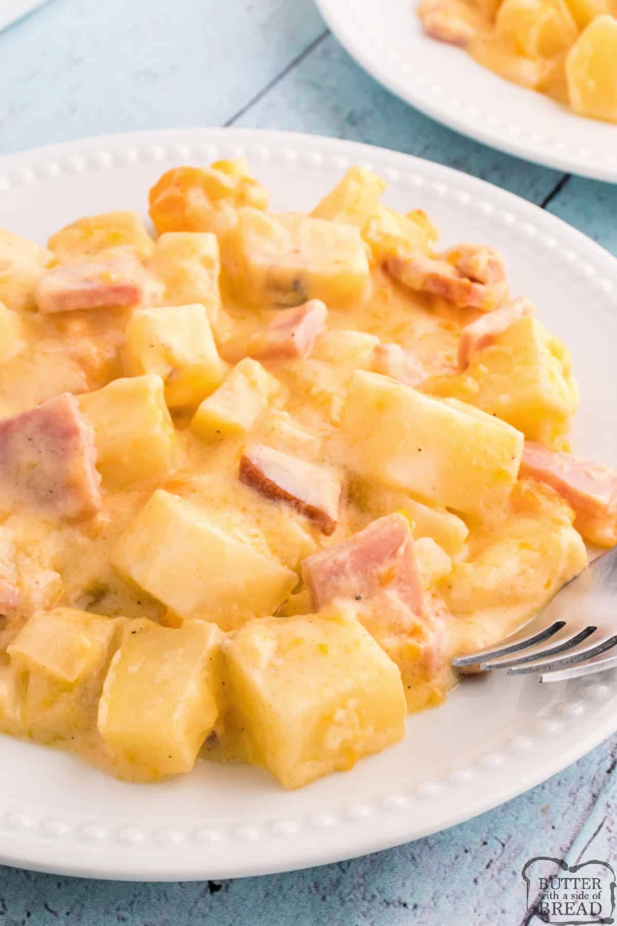 Serving of cheesy potatoes with ham. 