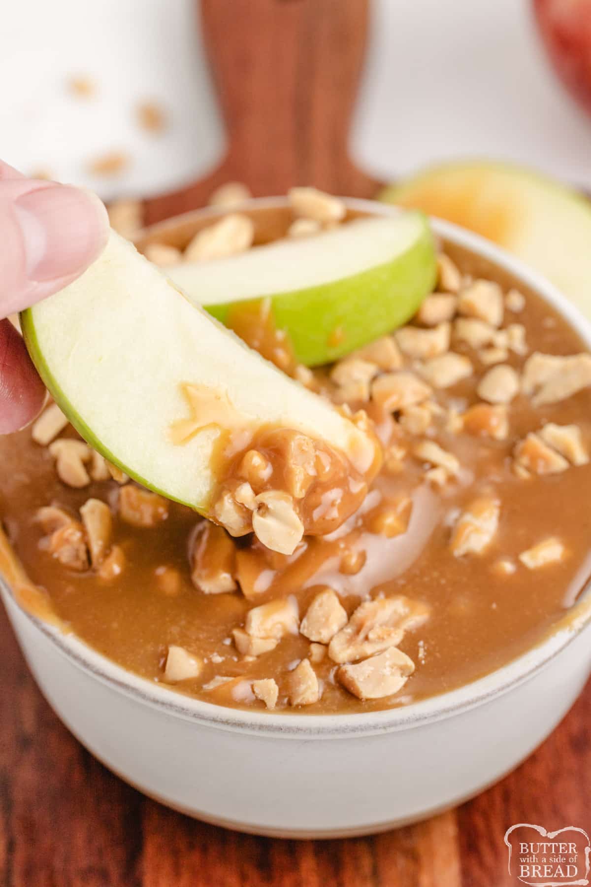 Creamy Caramel Peanut Butter Dip is made with 4 simple ingredients and is perfect for dipping apples. Made with melted caramels, milk, peanut butter, and chopped peanuts in less than 5 minutes!