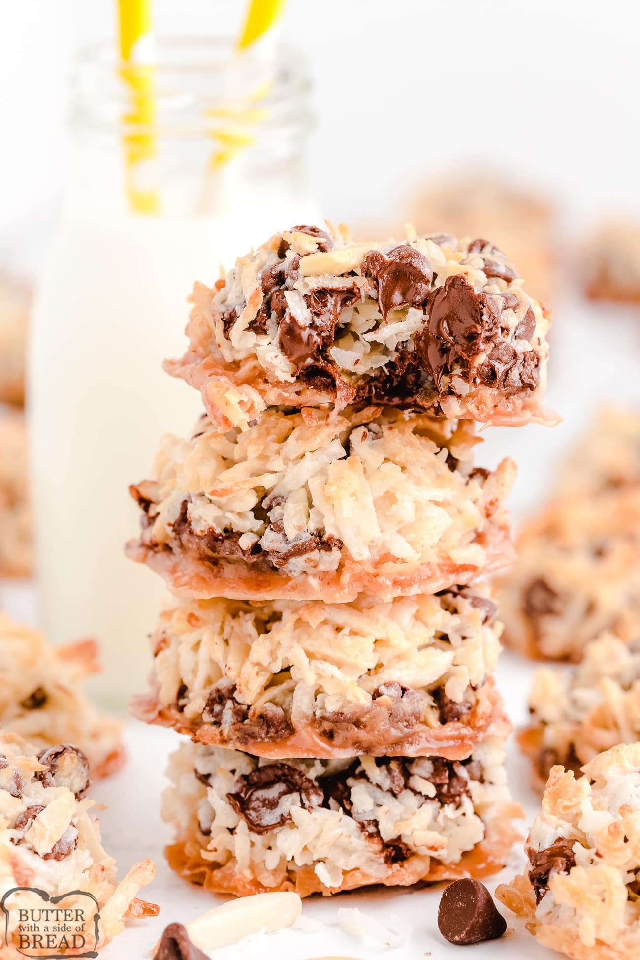 stacked almond joy cookies with a bite taken out of one