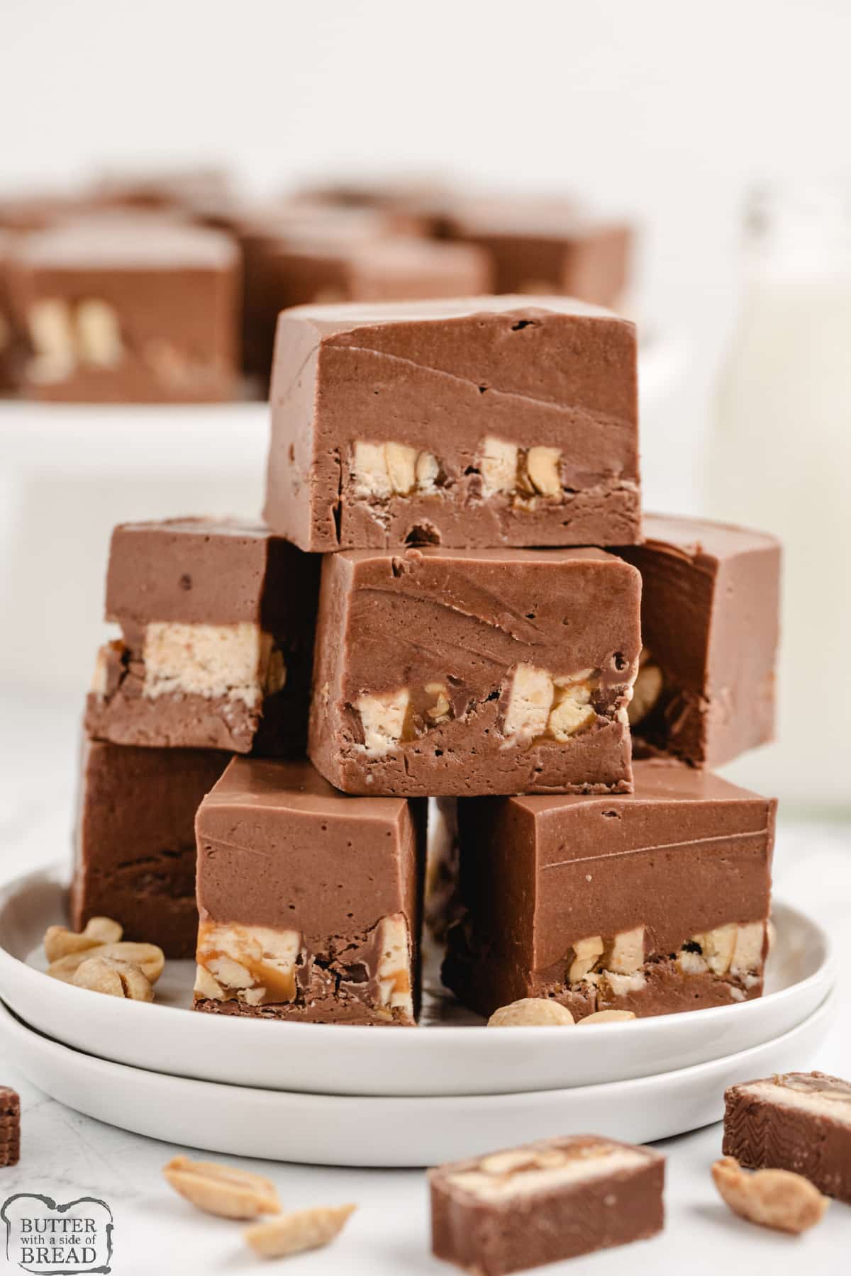 Snickers Fudge takes a traditional marshmallow cream fudge recipe to the next level by adding sliced Snickers bars in the middle! This rich and creamy fudge recipe is easy to make and absolutely delicious to eat. 