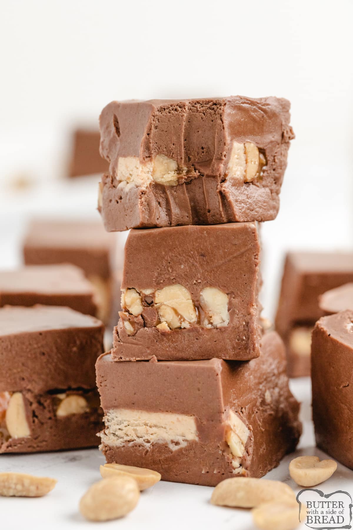 Snickers Fudge takes a traditional marshmallow cream fudge recipe to the next level by adding sliced Snickers bars in the middle! This rich and creamy fudge recipe is easy to make and absolutely delicious to eat. 
