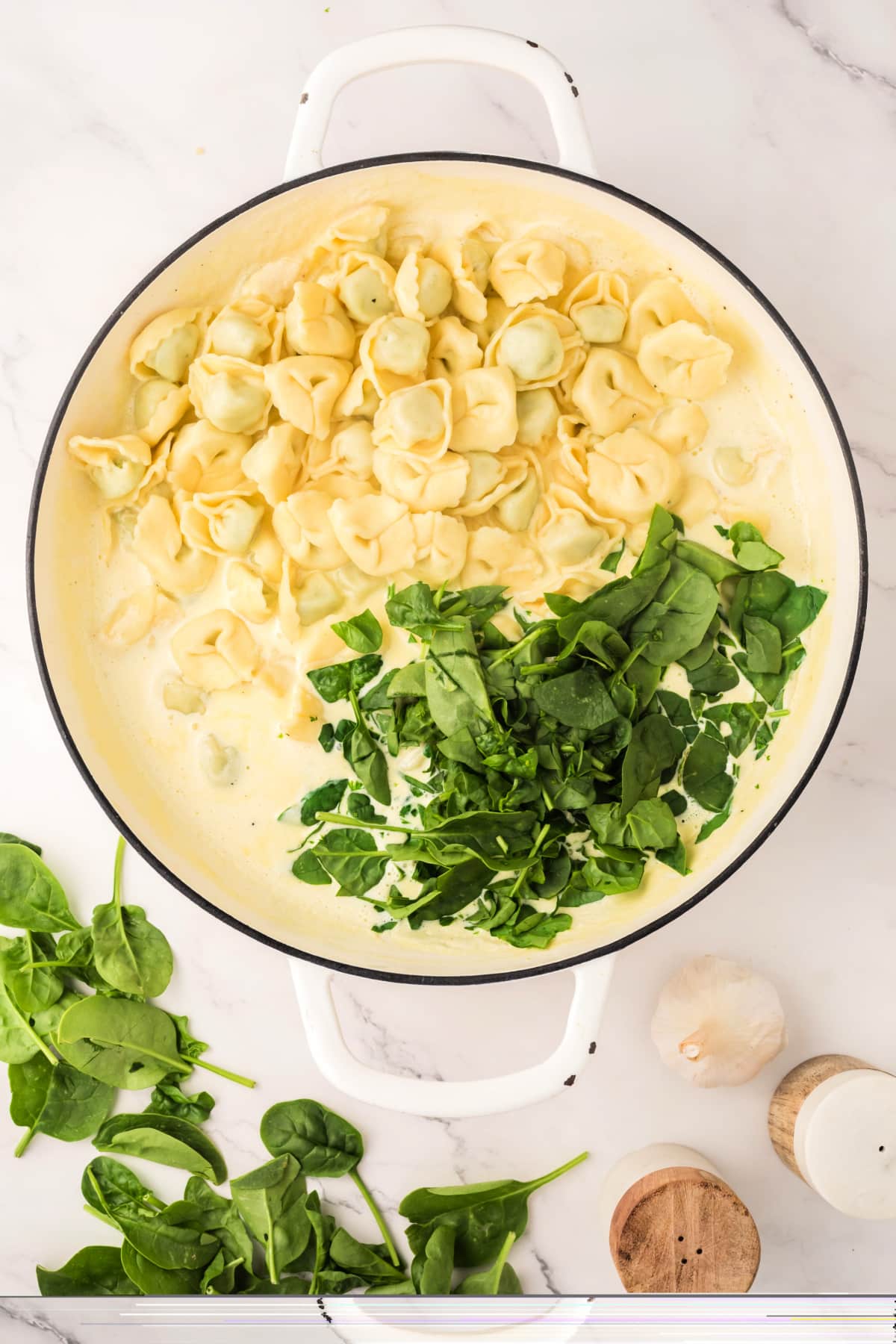 Add tortellini and spinach to homemade alfredo sauce. 
