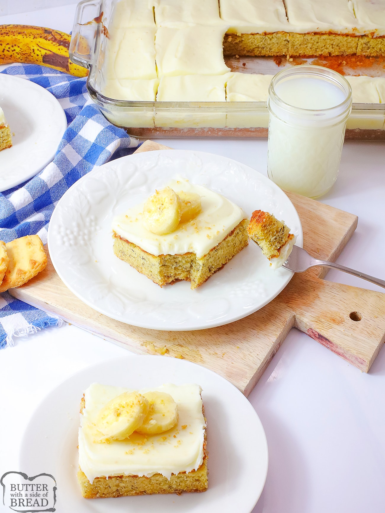 banana bars on white plates topped with slices of bananas