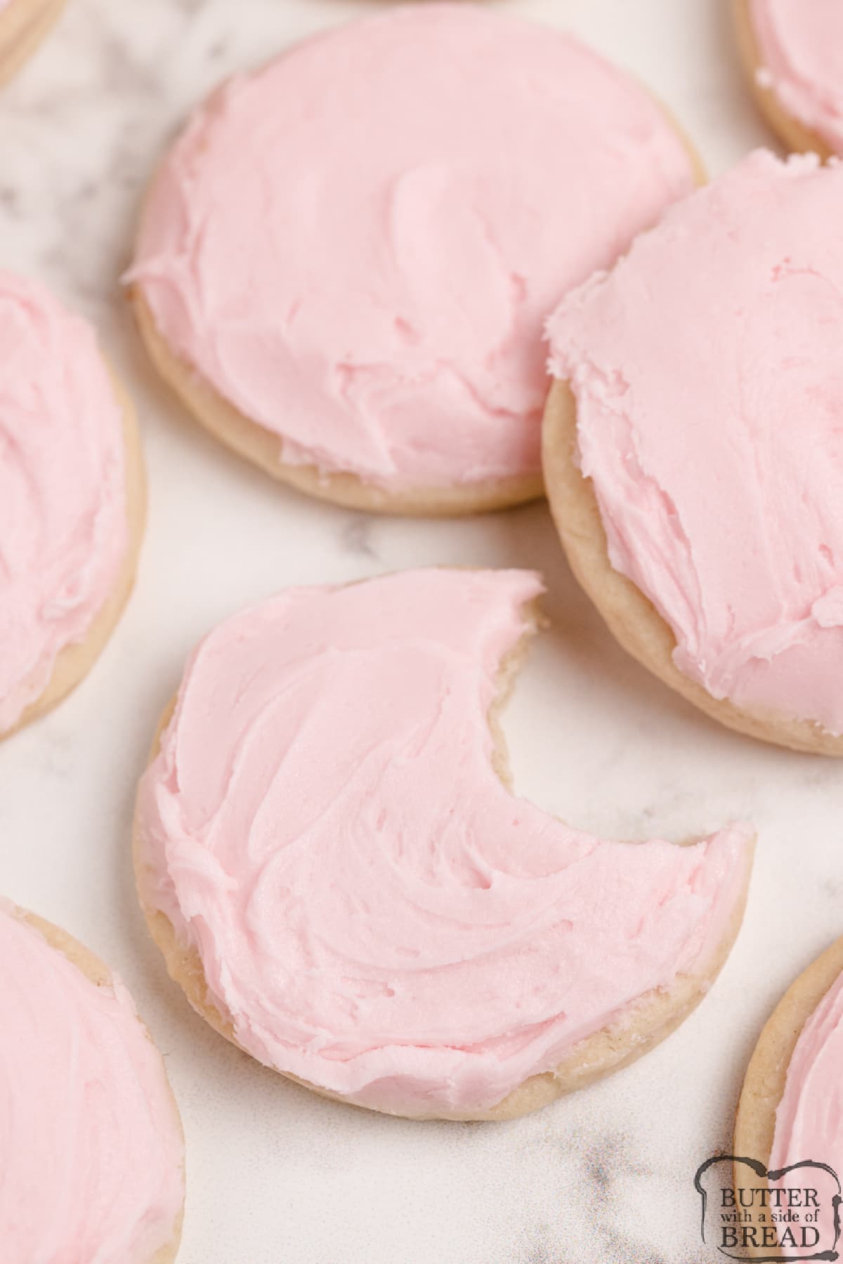 Thick sugar cookie with pink frosting. 