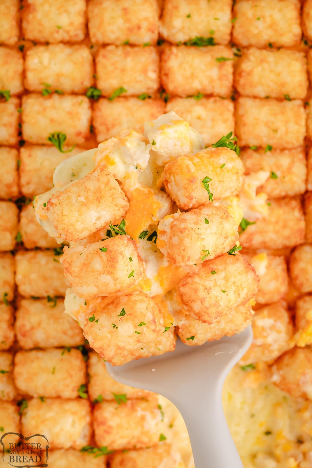 scooping out tater tot casserole