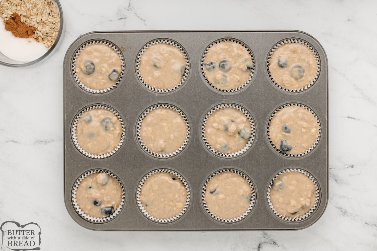 Blueberry muffin batter in muffin tin. 
