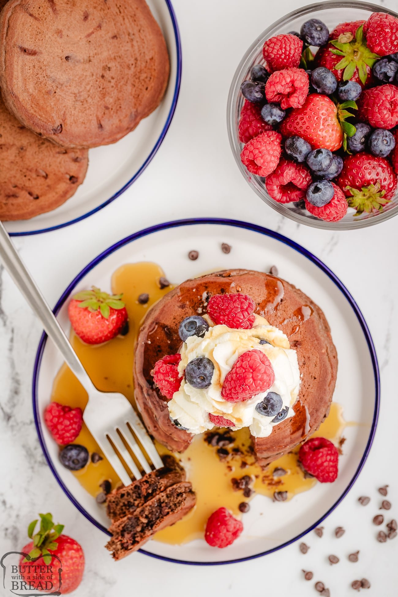 chocolate pancakes on a plate with berries