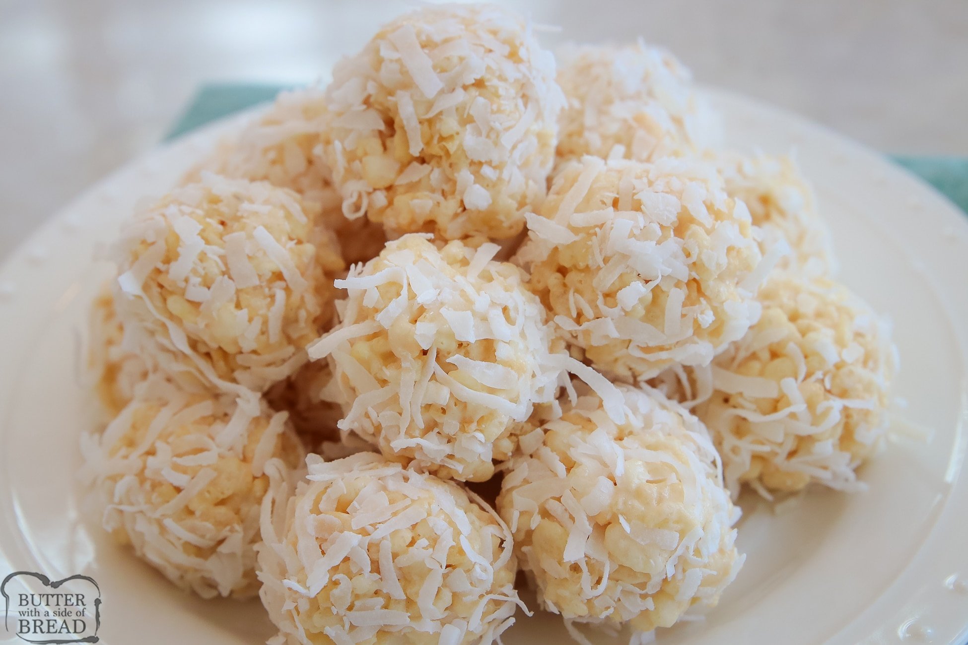 plate of rice krispie treats  that are rolled in coconut
