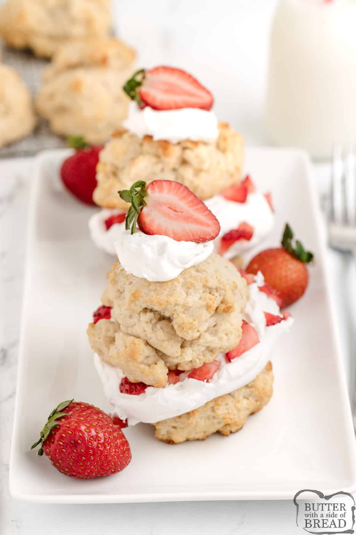 Individual shortcakes topped with whipped cream and strawberries. 