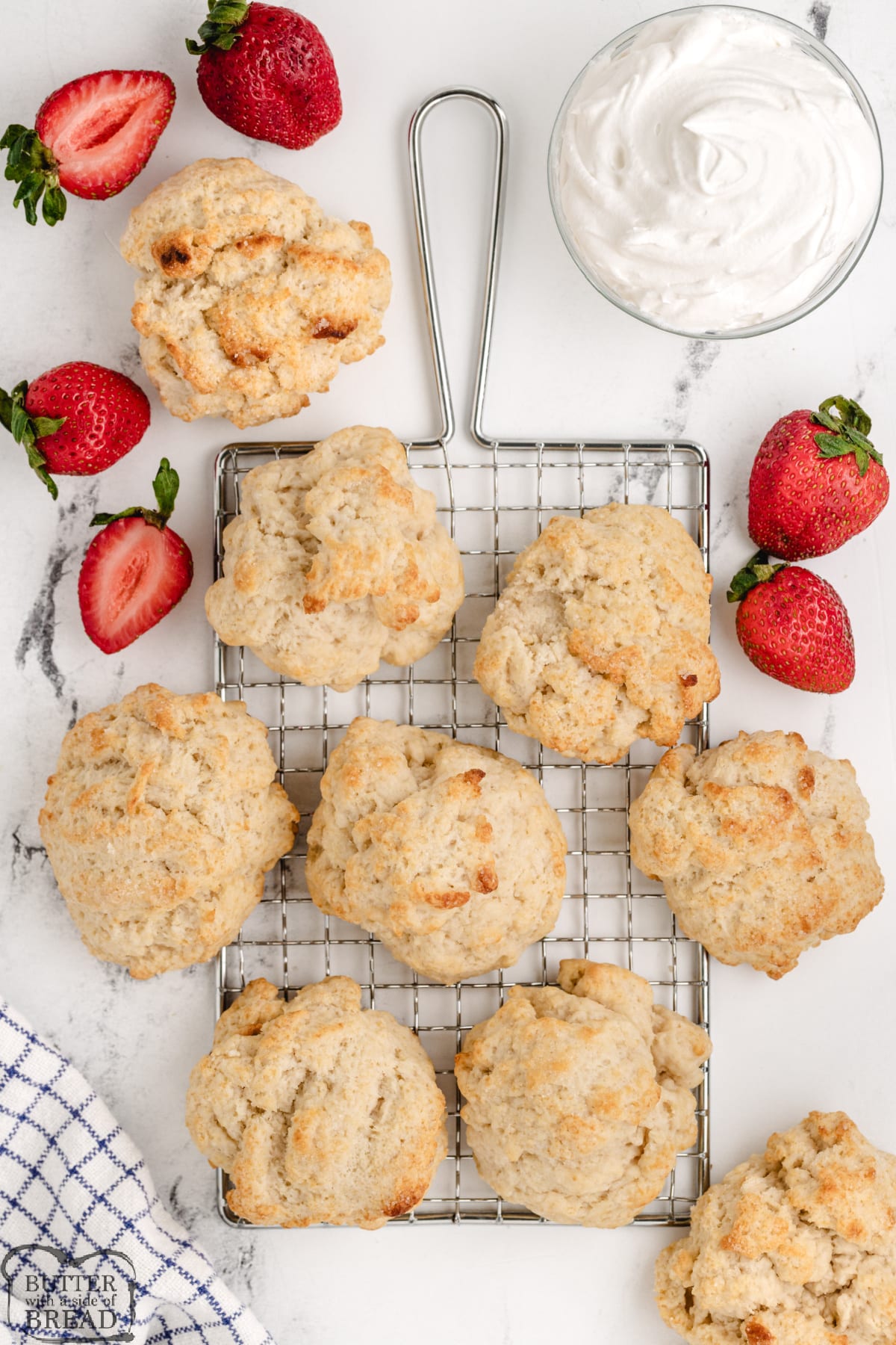 Add whipped cream and strawberries to baked shortcakes.