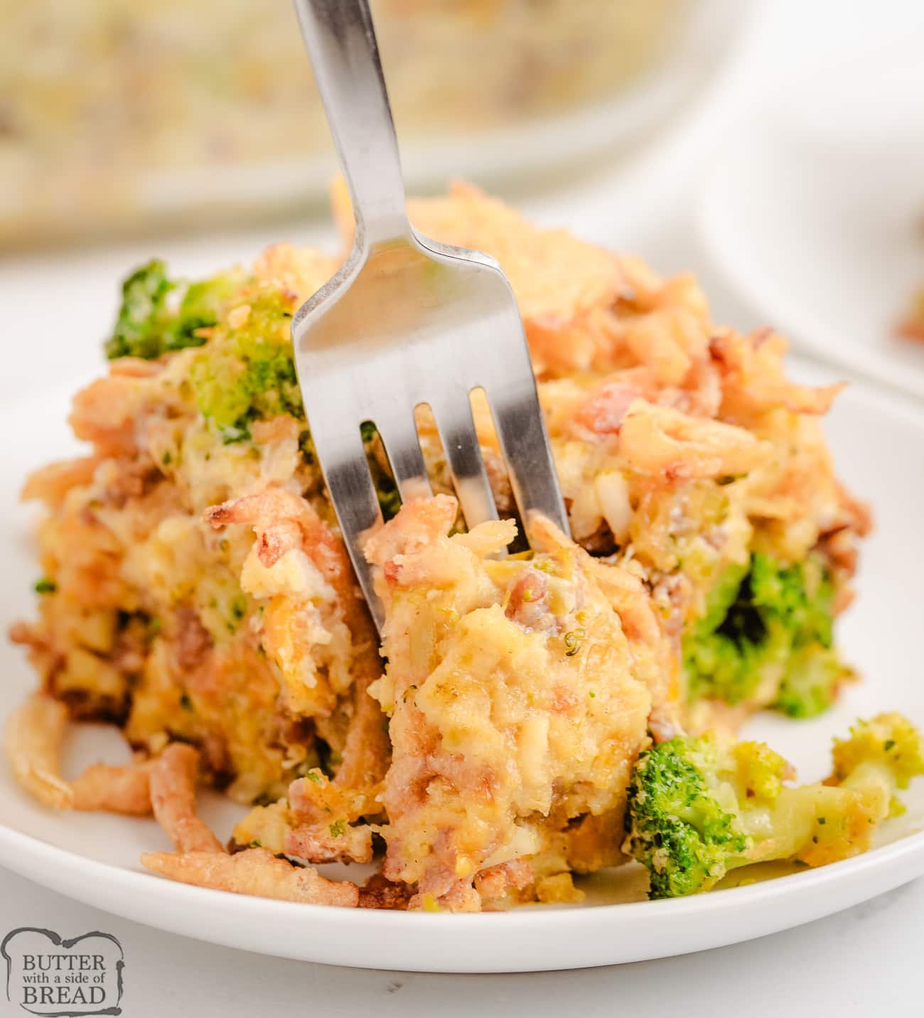 cheesy sausage broccoli casserole with eggs on a white plate