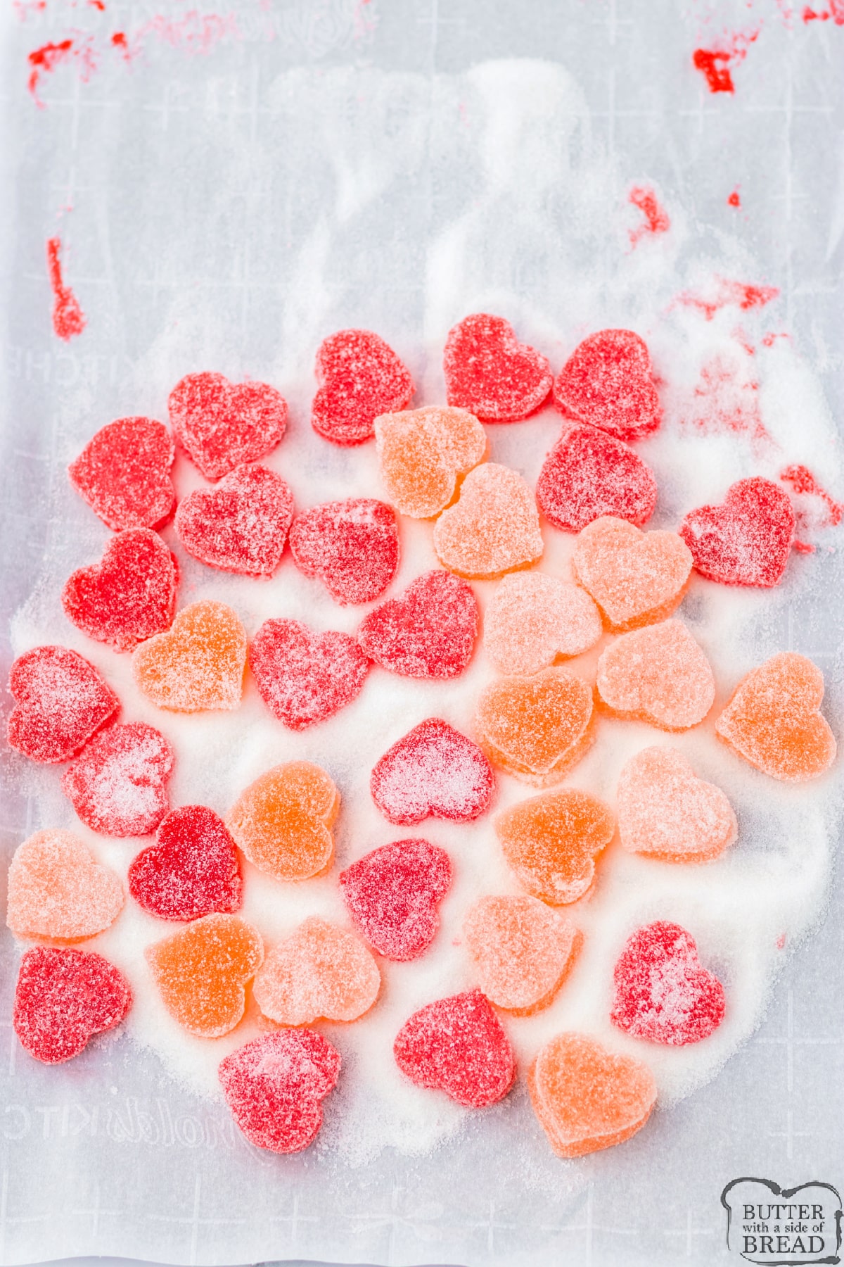 Coating heart candies in sour sugar mixture. 