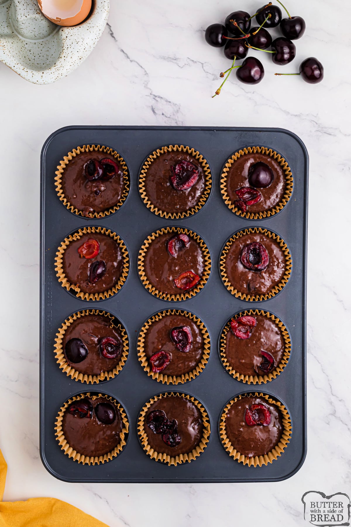 Scoop chocolate cherry muffins in muffin tin. 