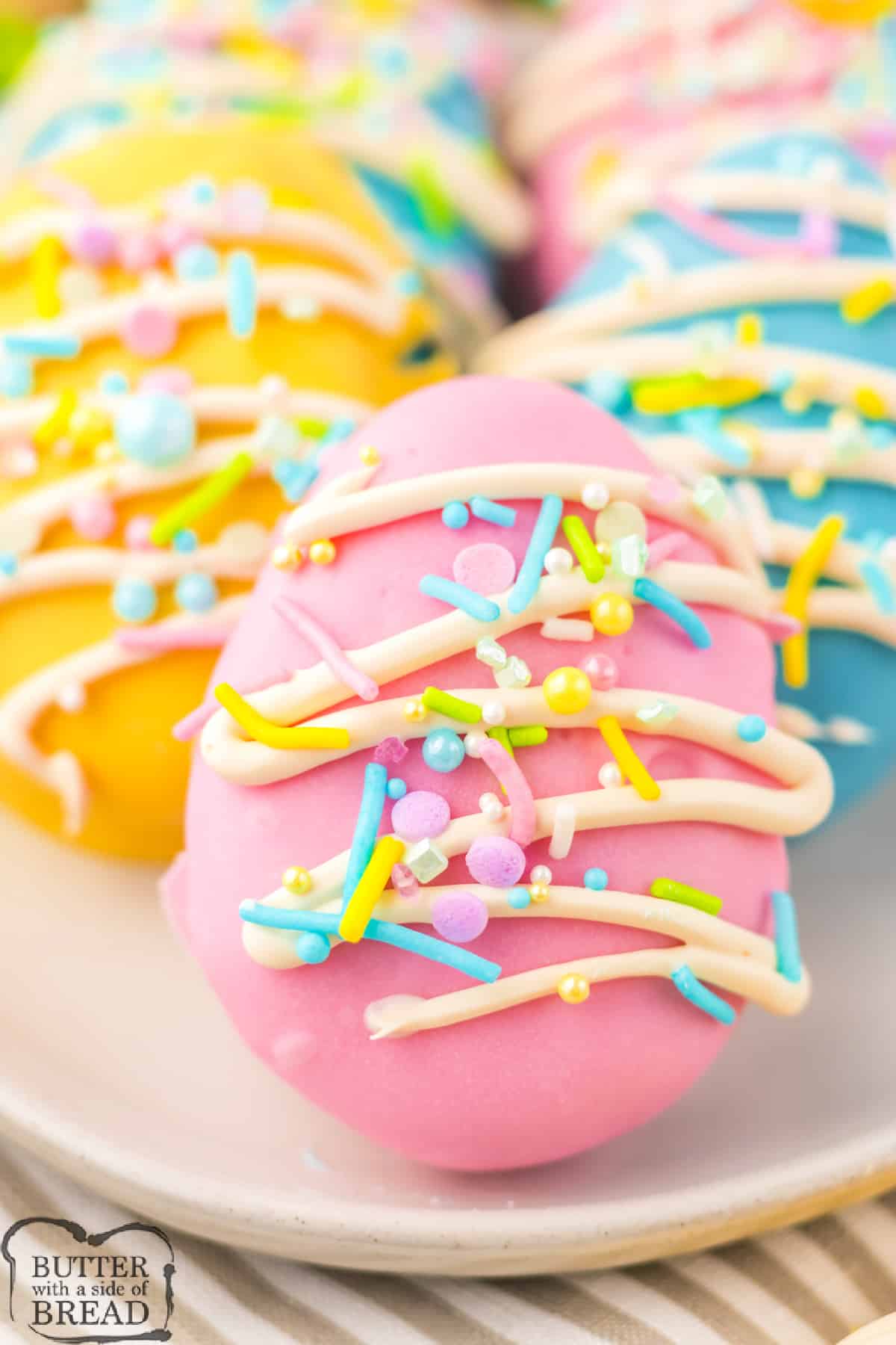 Cookie Dough Easter Eggs are the perfect no-bake dessert for Easter. Edible cookie dough in the shape of Easter eggs that are dipped in pastel-colored chocolate and then decorated.  