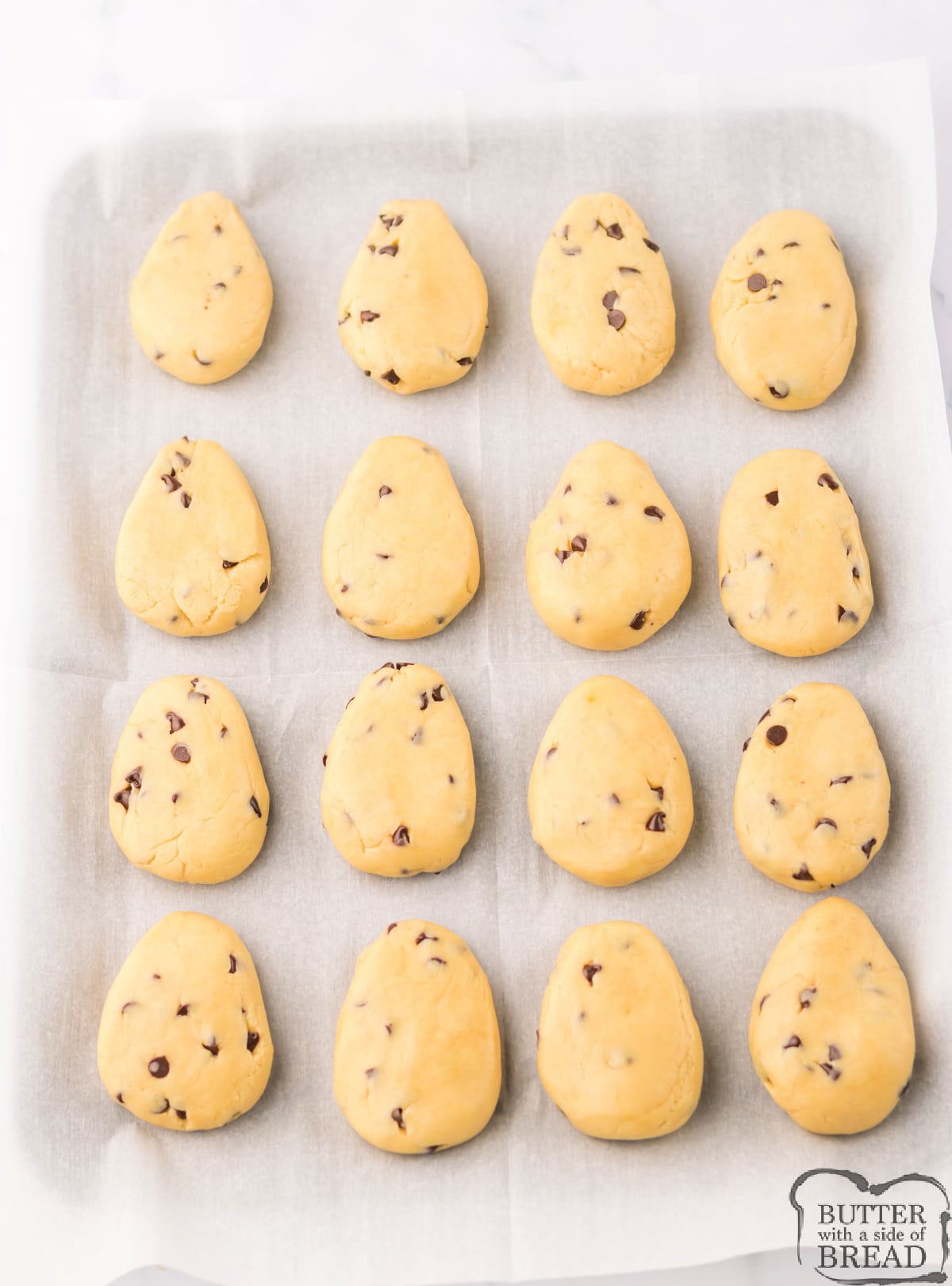 Shaping cookie dough into egg shapes.