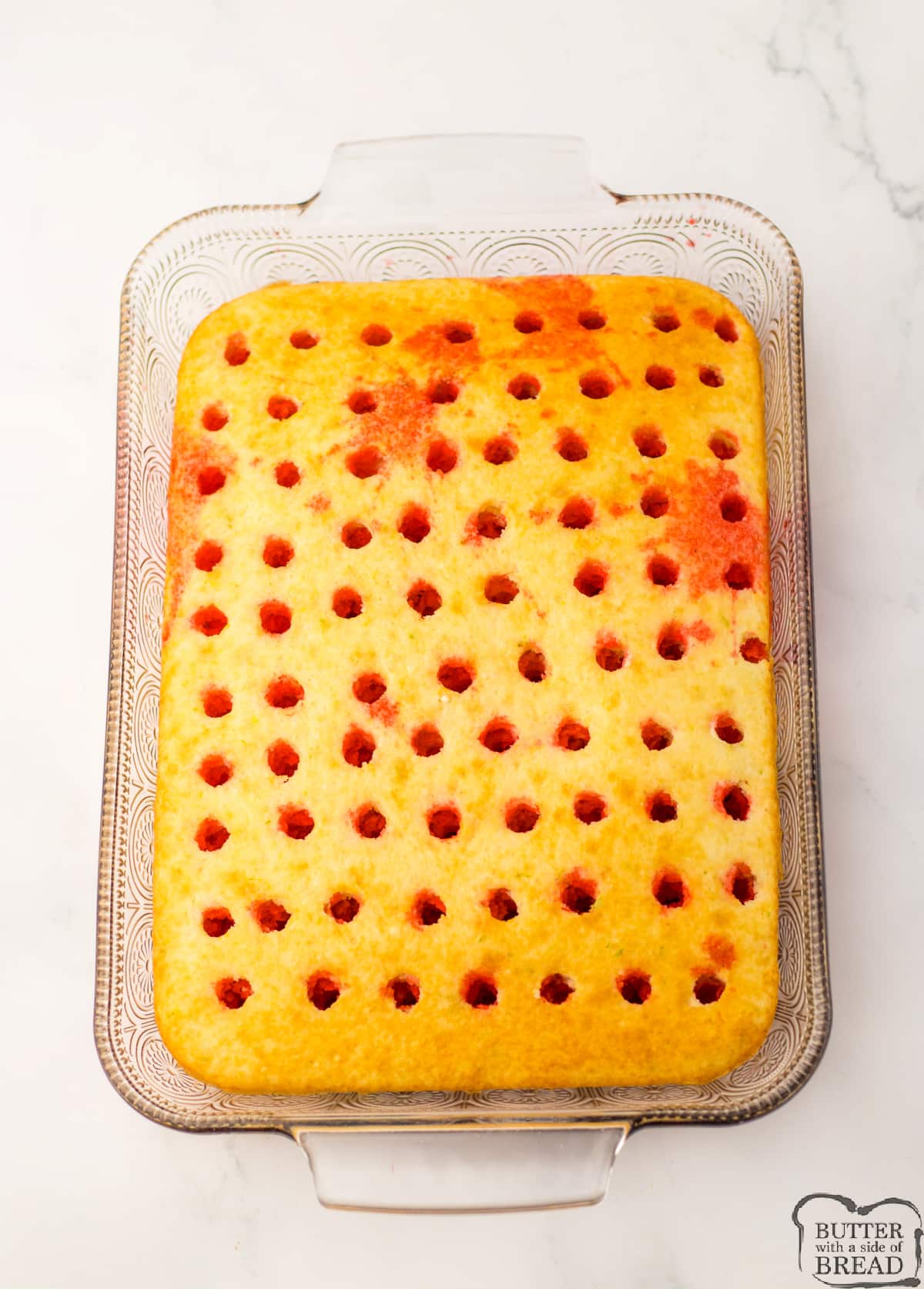 Pour jello into holes in poke cake. 