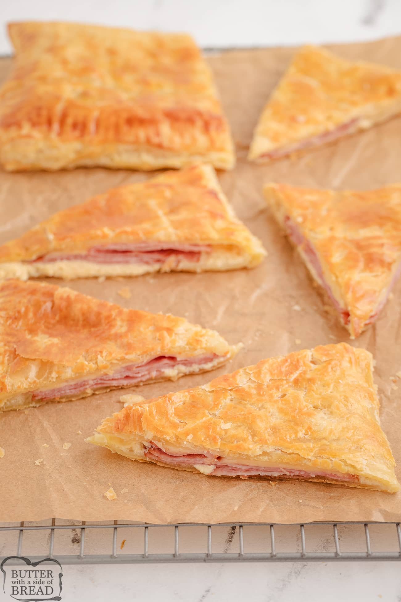flaky ham and cheese slab pies on a baking sheet