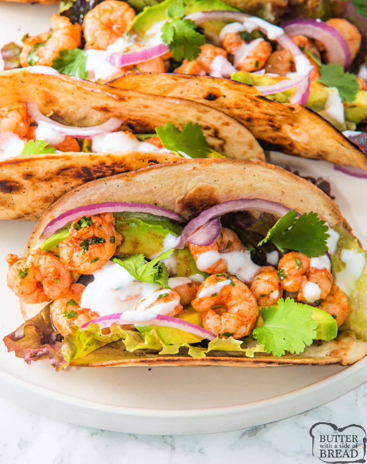 Spicy Shrimp Tacos are juicy and packed with flavor. Quick and easy dinner recipe that is ready to eat in less than 15 minutes!