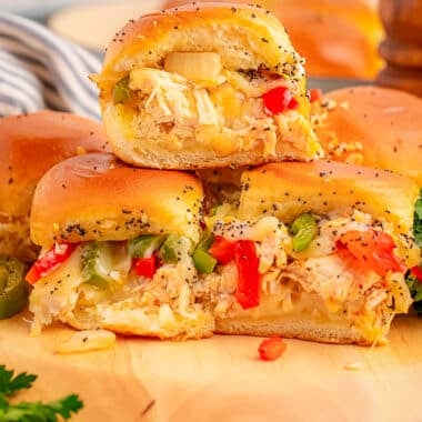 cheesy philly chicken sliders on a wooden cutting board