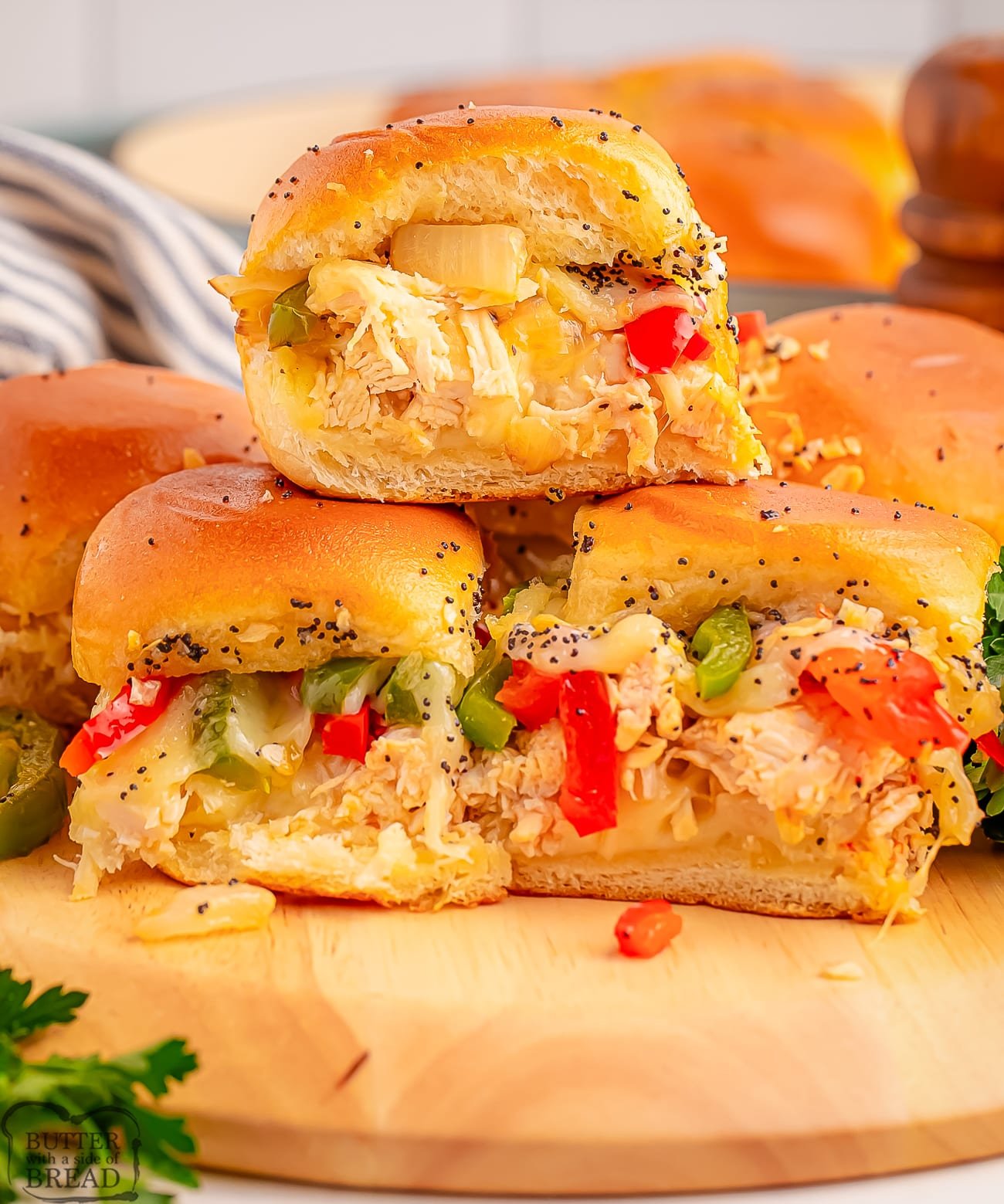 cheesy philly chicken sliders on a wooden cutting board