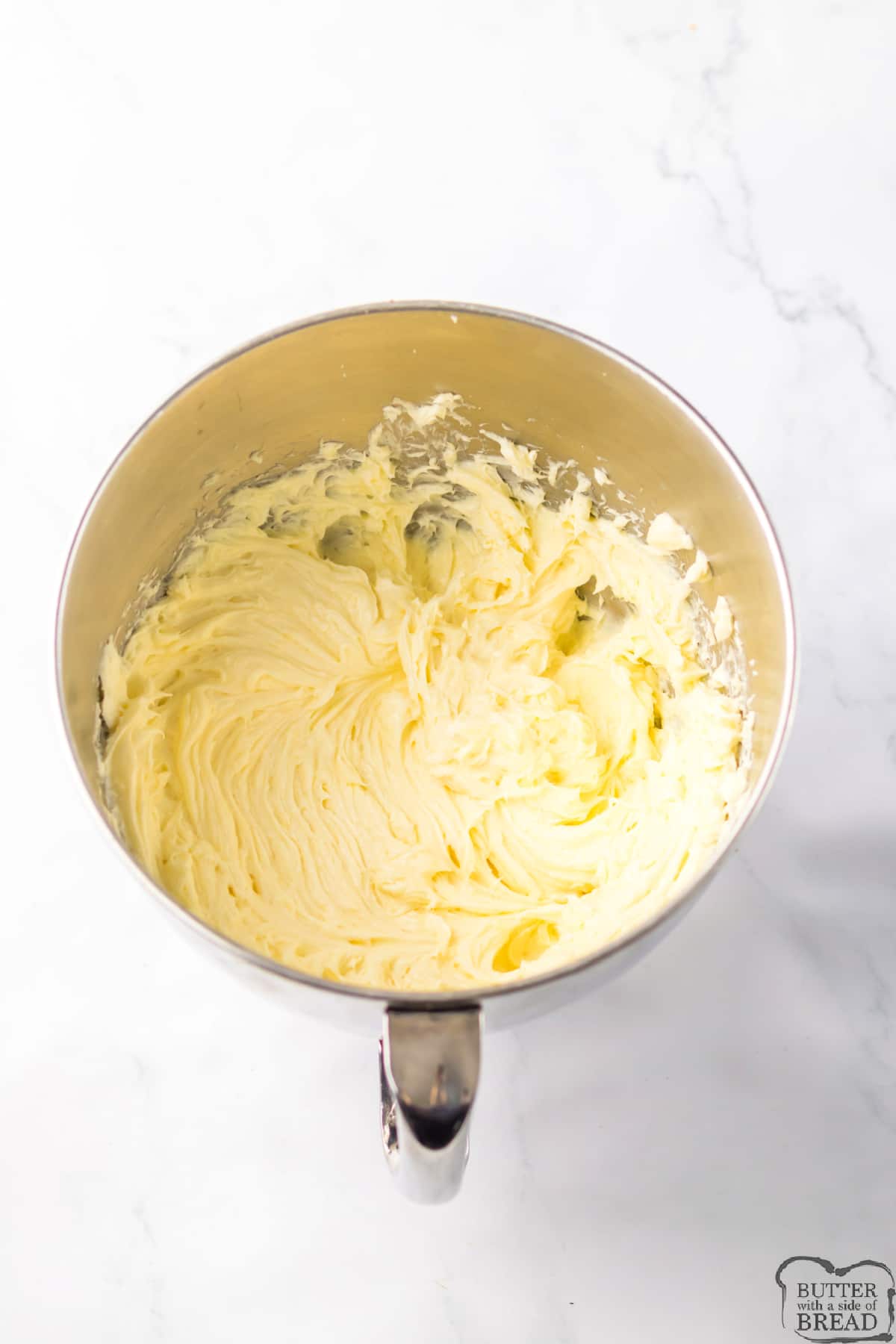 Beating cream cheese until smooth and fluffy.