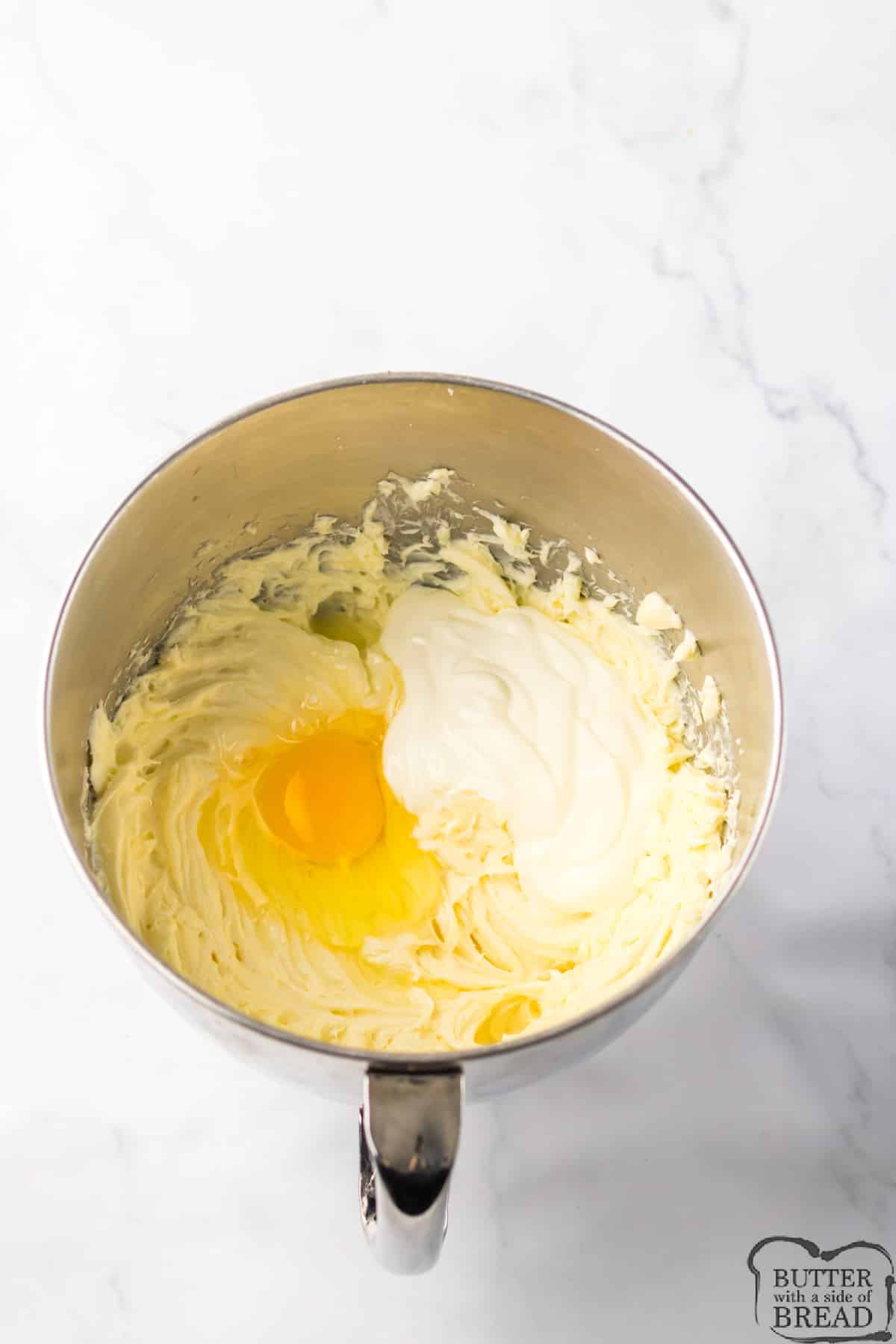 Adding eggs and sour cream to mixture. 