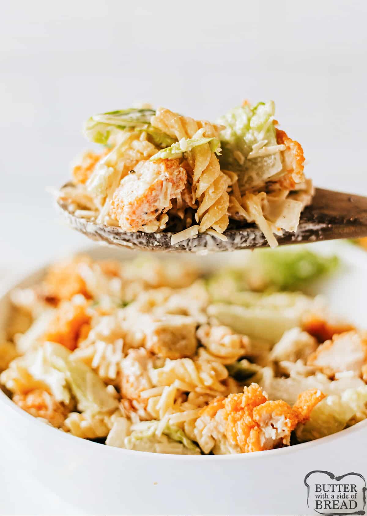 Chicken Caesar Pasta Salad is a great way to turn a salad into a filling main dish! This Caesar salad recipe is made with rotini, crispy chicken tenders, and shredded parmesan.