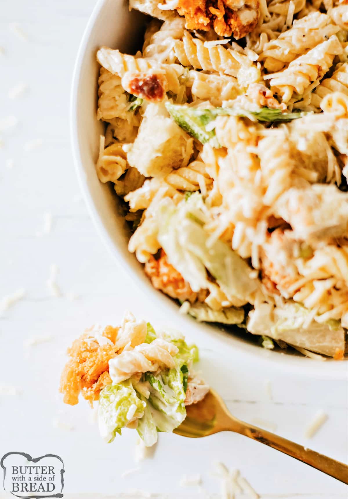 Bite of pasta salad with Caesar dressing, chicken, and croutons. 