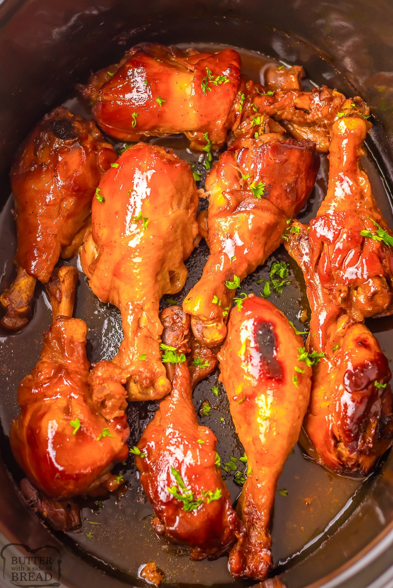 chicken drumsticks slow cooking in a Dr. Pepper BBQ sauce