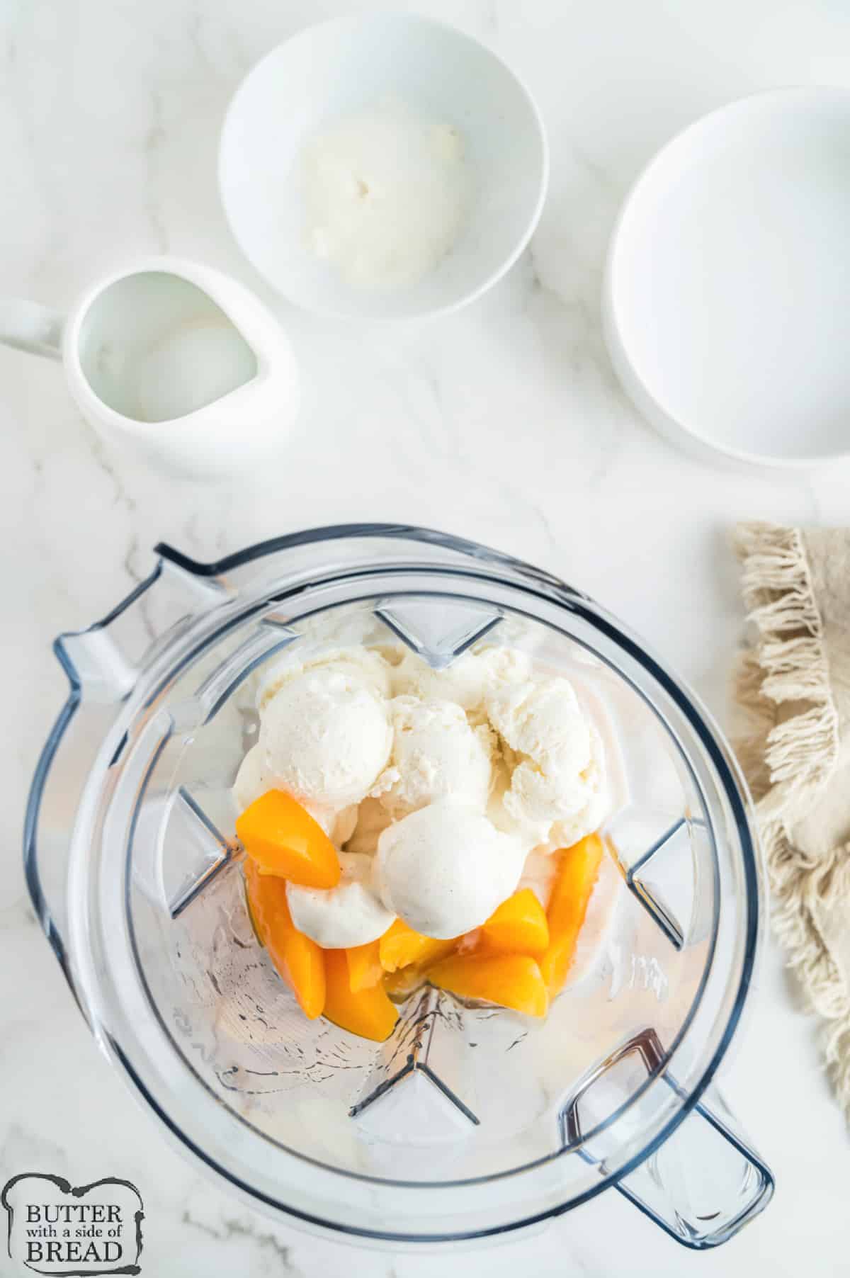Peaches, ice cream, and milk in a blender. 