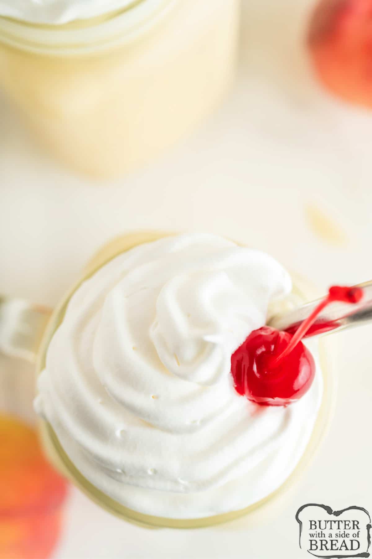 Whipped cream and cherry on top of a shake.
