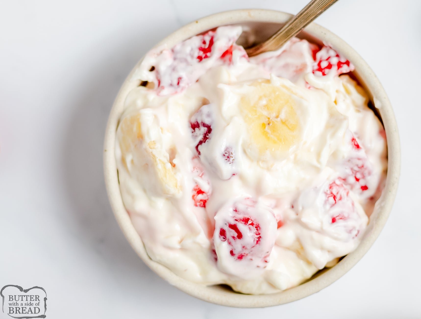 small bowl with strawberry banana cheesecake salad