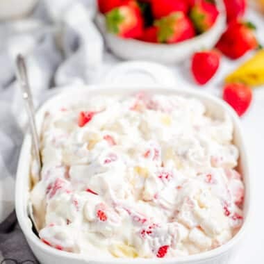 big bowl of strawberry banana salad with cheesecake cream