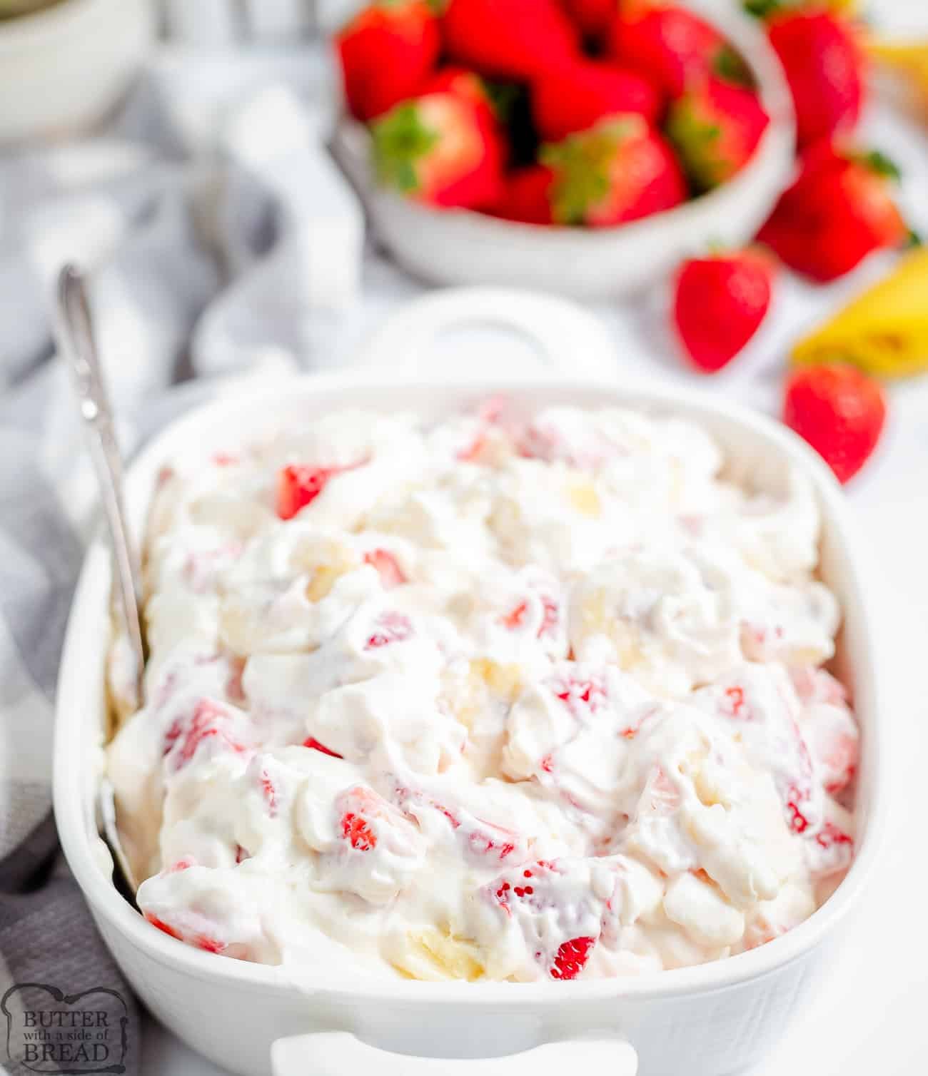 big bowl of strawberry banana salad with cheesecake cream