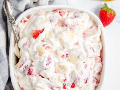 strawberry banana cheesecake salad in a white bowl