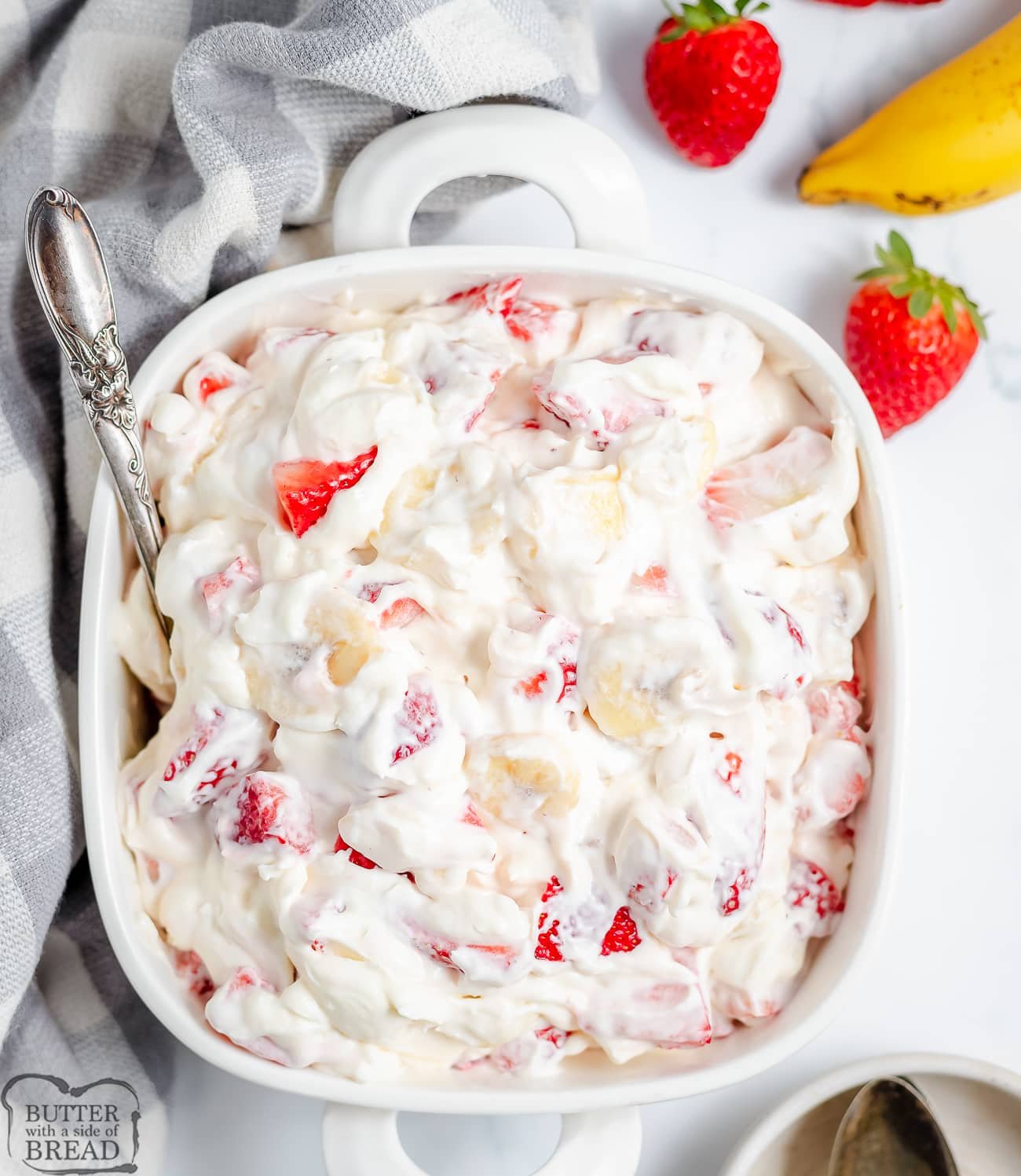 strawberry banana cheesecake salad in a white bowl