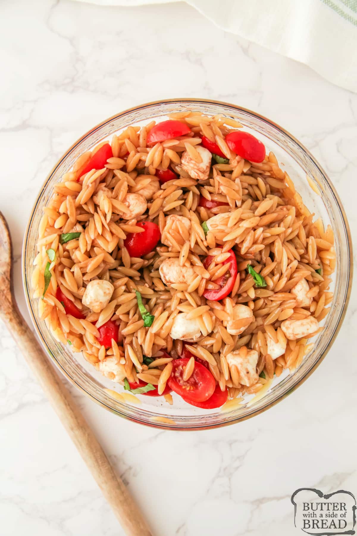 Caprese Orzo Salad is a light and fresh pasta salad made with mozzarella pearls, cherry tomatoes, and balsamic vinegar. An easy and delicious side dish for any barbecue or party!