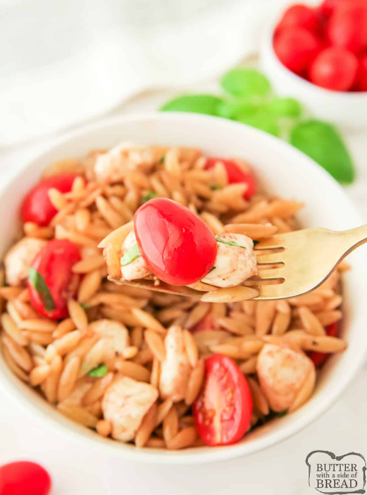 Pasta salad made with tomatoes, mozzarella, and basil. 