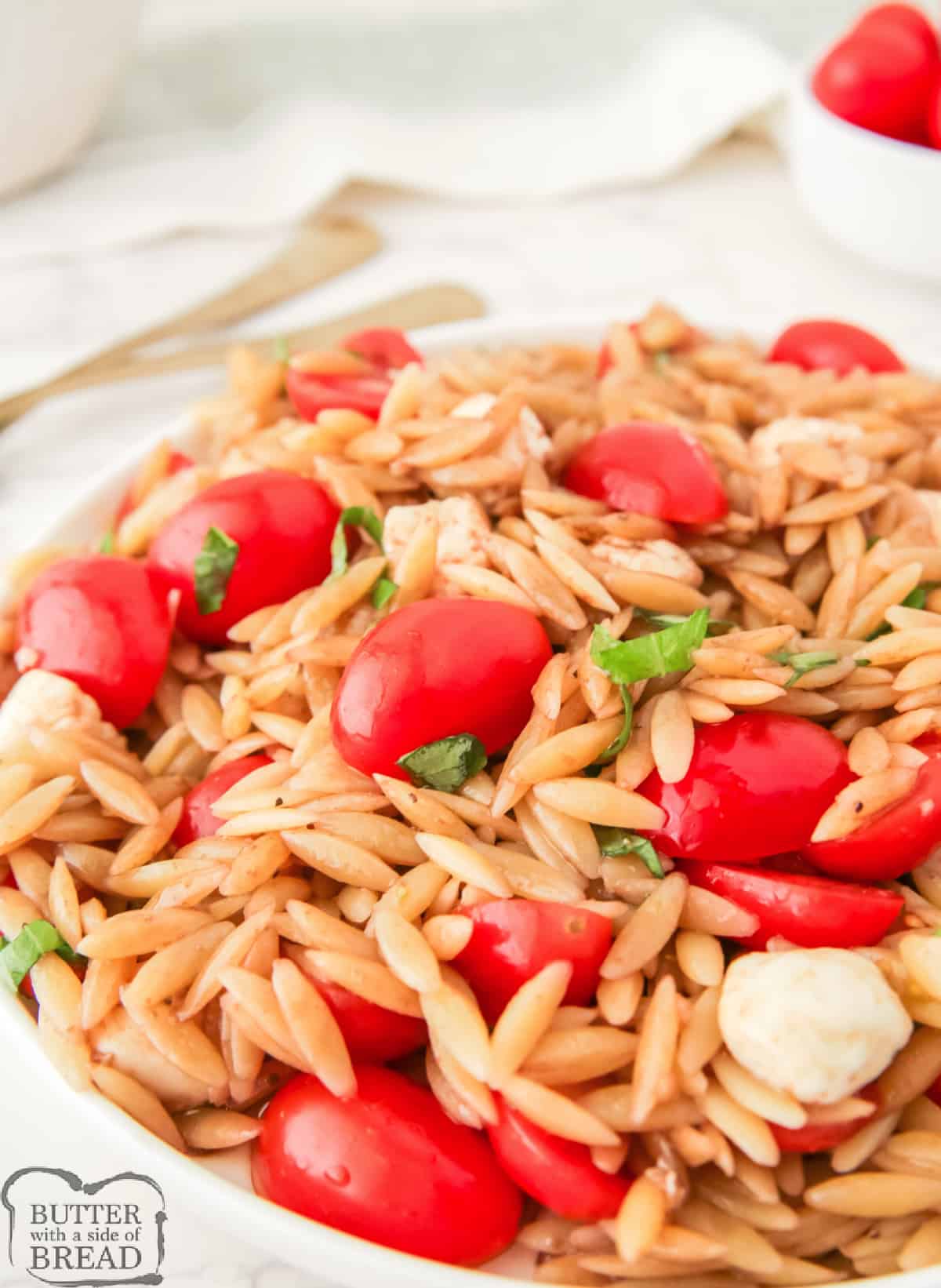 Caprese Orzo Salad is a light and fresh pasta salad made with mozzarella pearls, cherry tomatoes, and balsamic vinegar. An easy and delicious side dish for any barbecue or party!