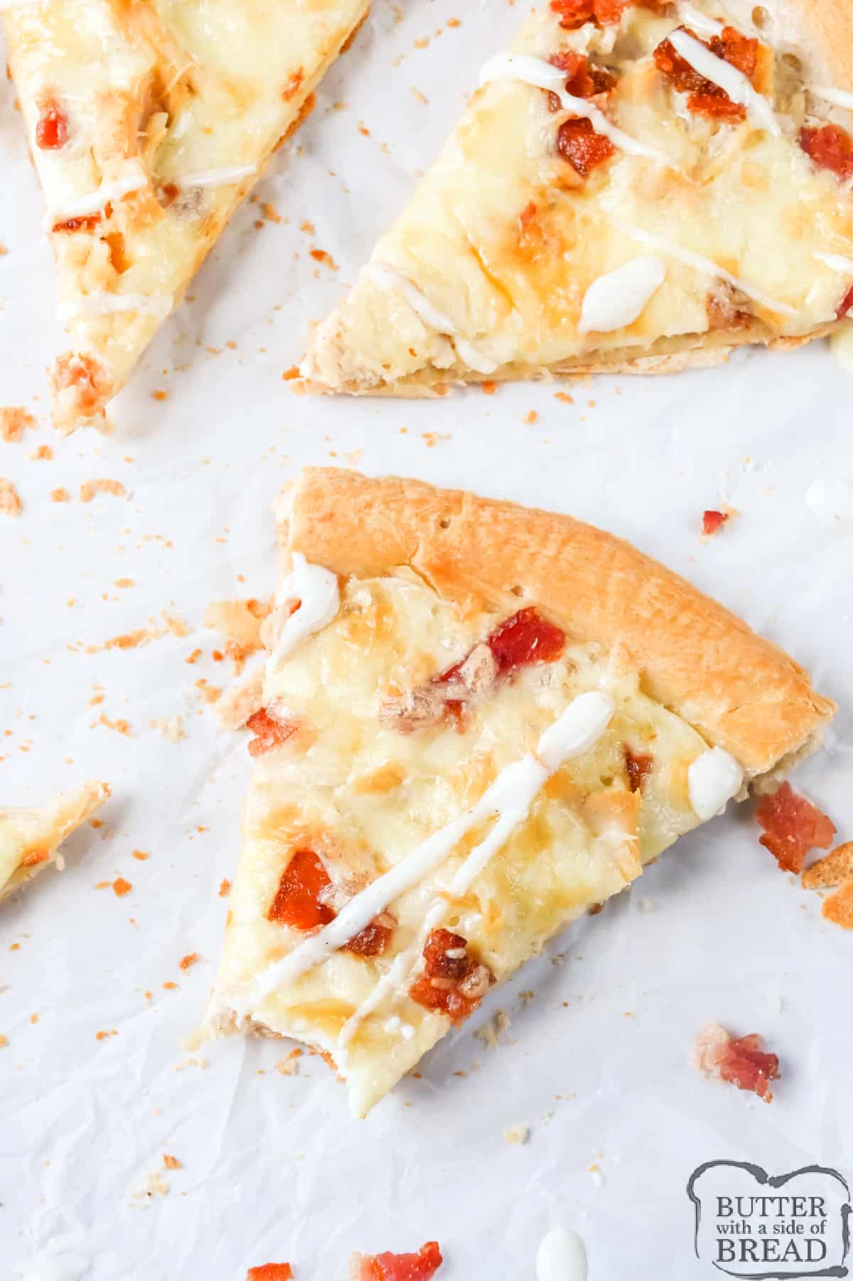 Slice of ranch pizza with chicken and bacon. 