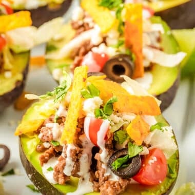 avocados cut in half, the pit removed, then stuffed with beef taco filling