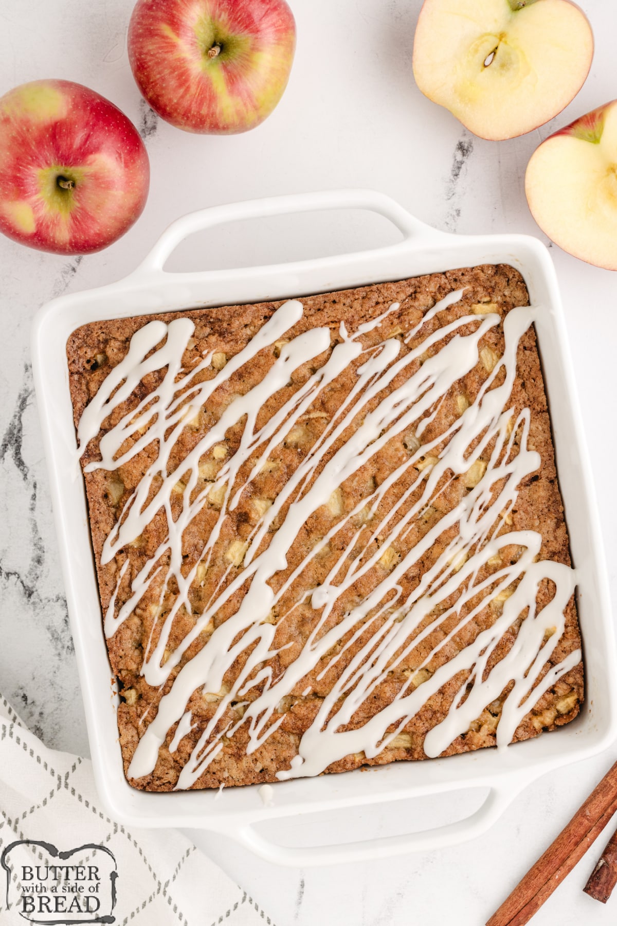 Cooked coffee cake drizzled with powdered sugar glaze.