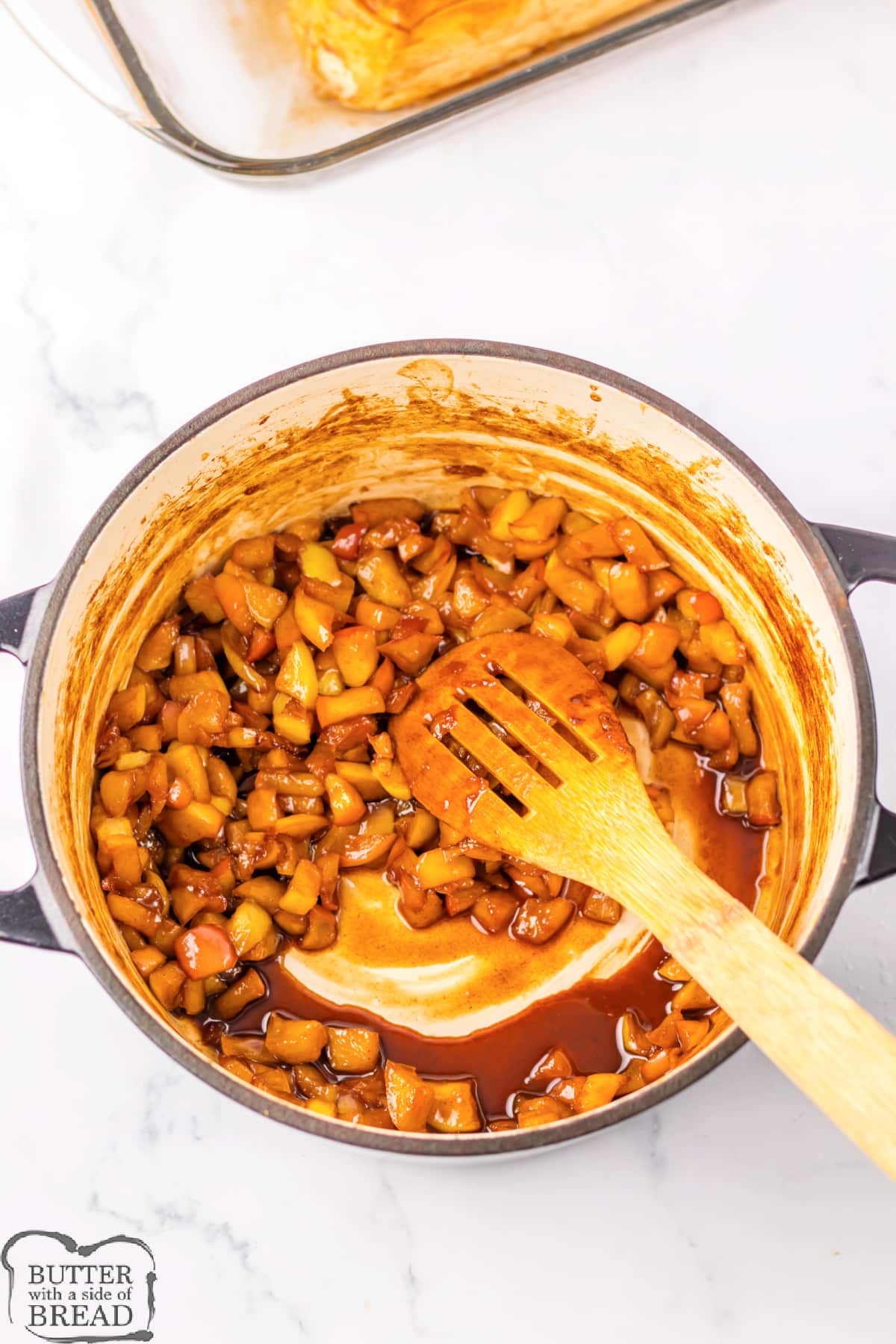 Mixing diced apples with cinnamon, brown sugar, and caramel sauce. 