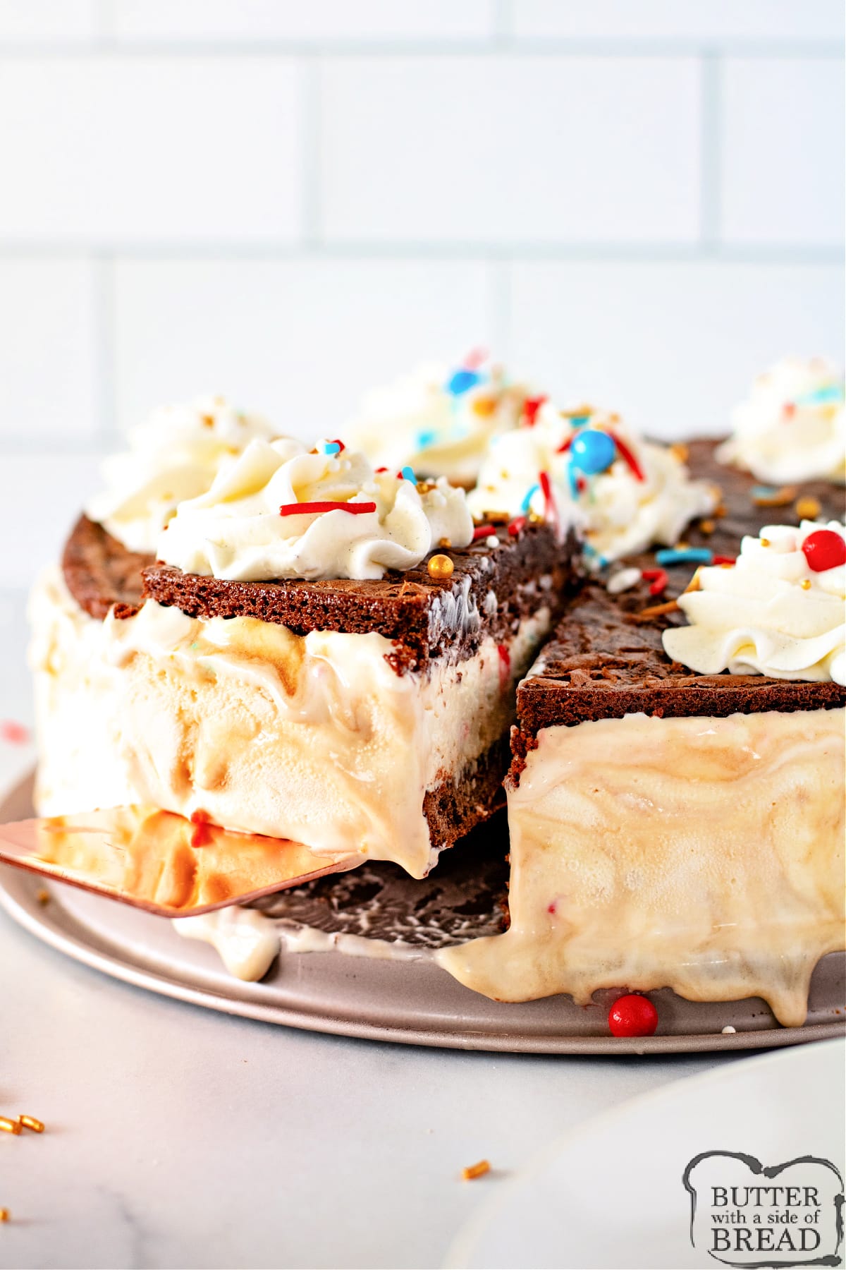 Caramel Brownie Ice Cream Cake is made with a simple homemade vanilla ice cream sandwiched between two layers of brownies. Caramel sauce is swirled into the ice cream to add even more flavor to this delicious frozen dessert.