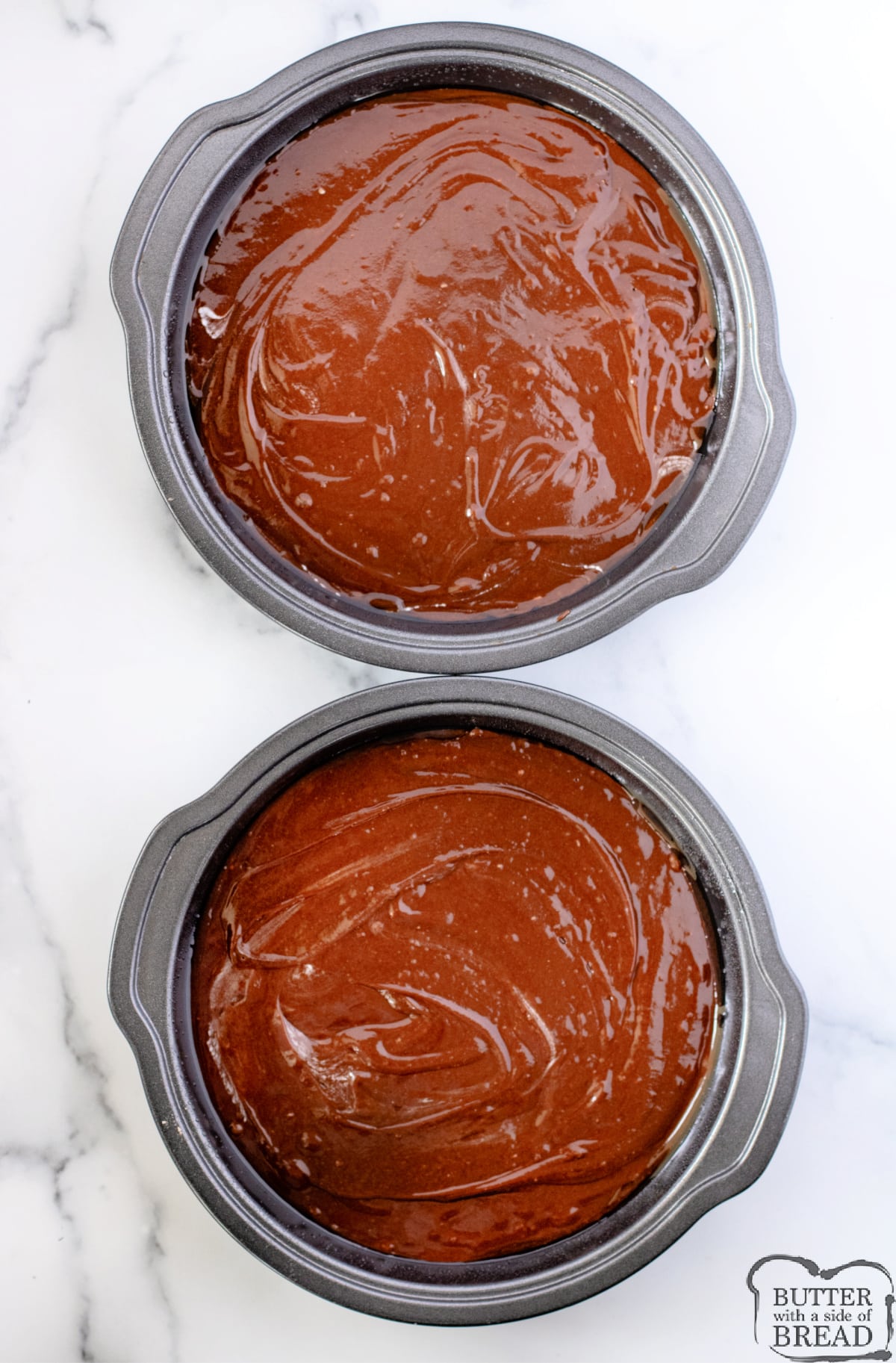 Two cake pans with brownie batter. 