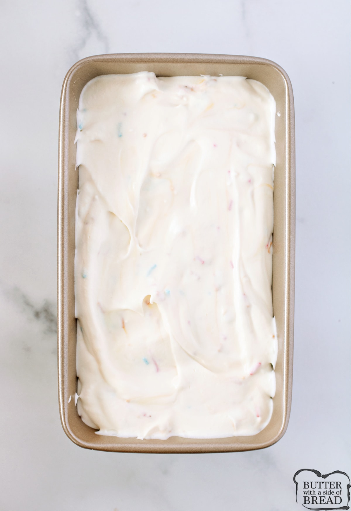 Pouring homemade ice cream into loaf pan. 