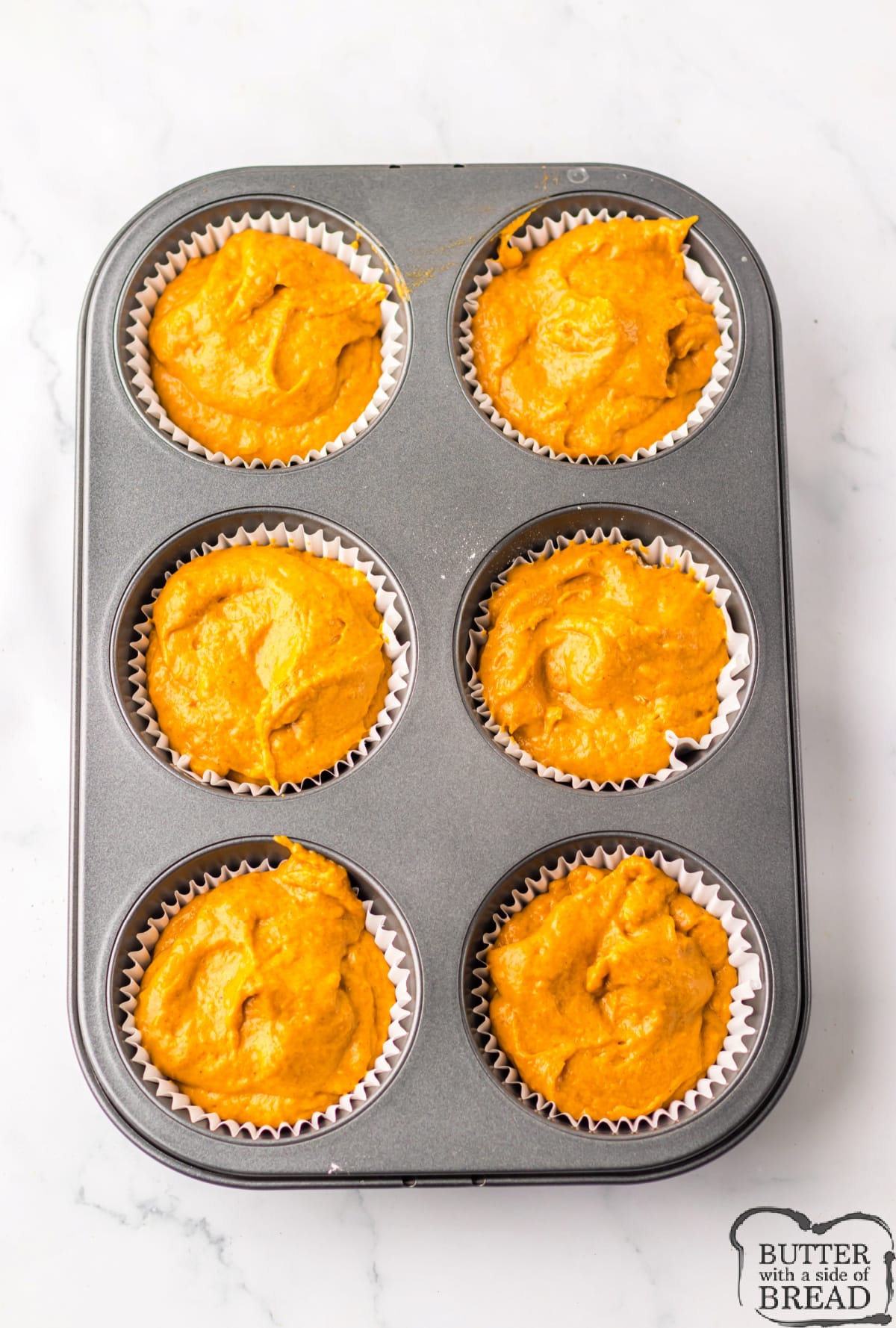 Pumpkin batter in muffin tin.