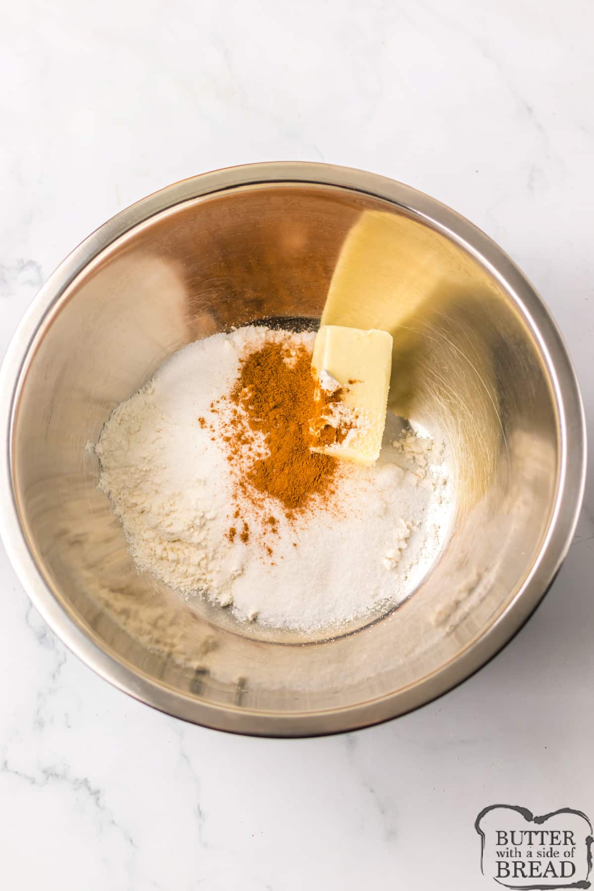 Mixing butter, cinnamon, sugars, and flour together to make crumb topping. 