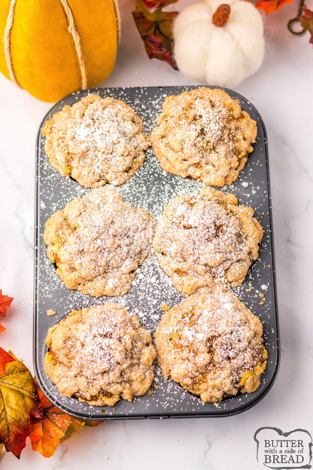 Baked pumpkin muffins with dusting of powdered sugar. 